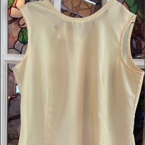 Pale yellow sleeveless blouse bottons up back. Vintage. Perfect condition.
